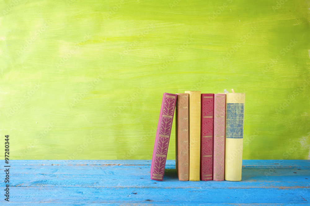 Fototapeta premium row of books, free copy space on green background