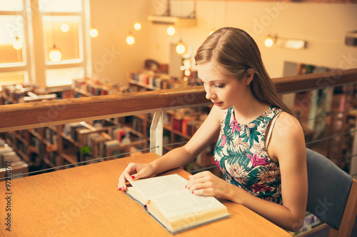 Beautiful young woman student in library