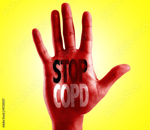 Stop COPD written on hand with yellow background photo