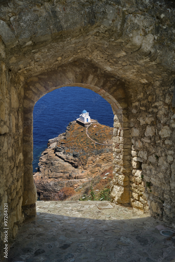 Small church through old castle on Santorini island, Greece