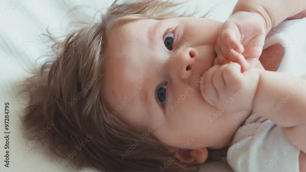 Closeup face of a happy newborn baby girl boy. Top view Closeup face of a happy newborn baby girl boy. Top view