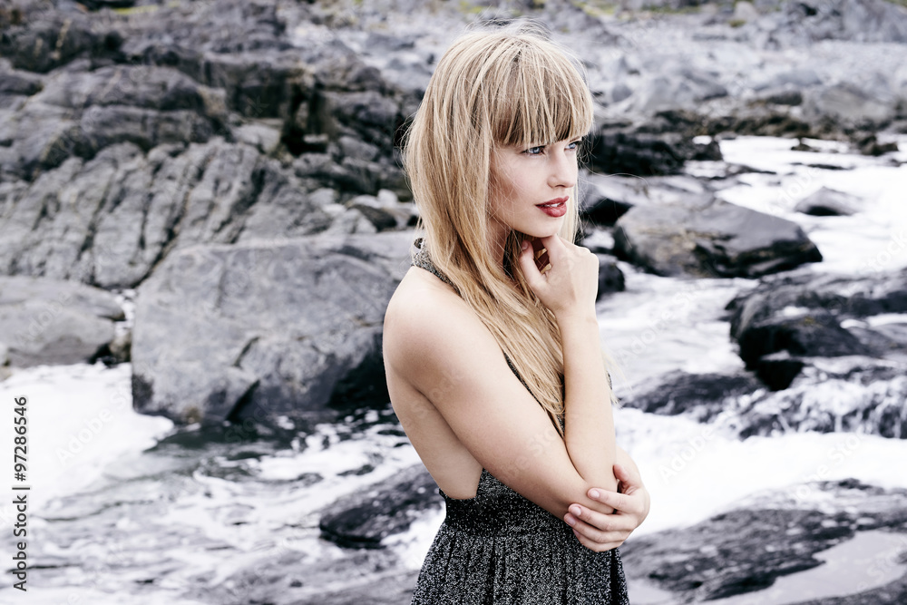 Gorgeous young woman amongst rocks