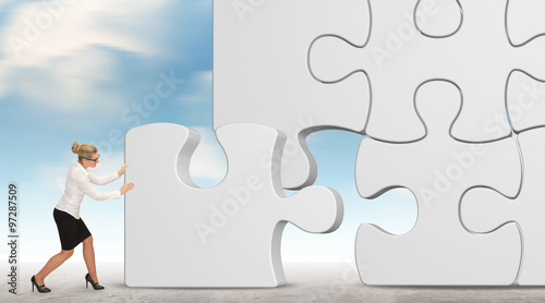 business woman building a white puzzle on a sky background 