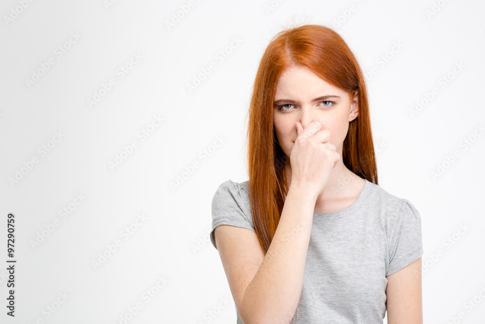 Beautiful young woman closed her nose by hand Beautiful young woman closed her nose by hand