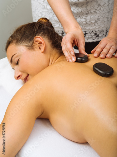 Placing hot stones during massage