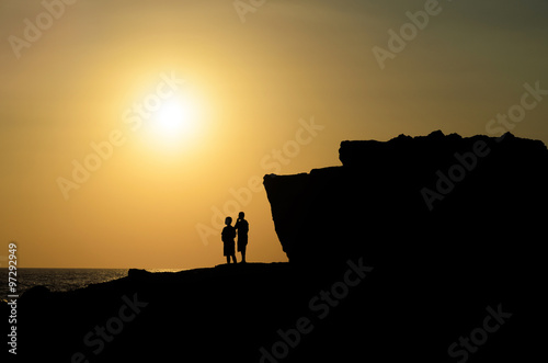 Silhouette people view sunset from mountain