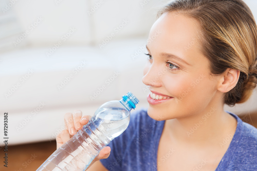 happy woman with water bottle at home happy woman with water bottle at home