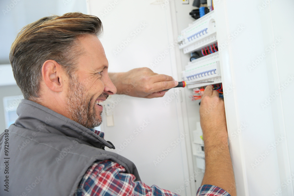 Electrician fixing electric panel in private home Electrician fixing electric panel in private home
