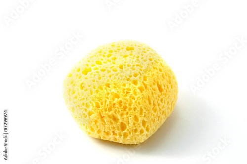 Yellow porous sponge on a white background