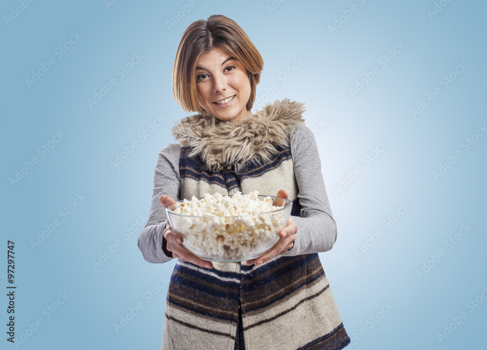 beautiful young woman holding a bowl of popcorn beautiful young woman holding a bowl of popcorn