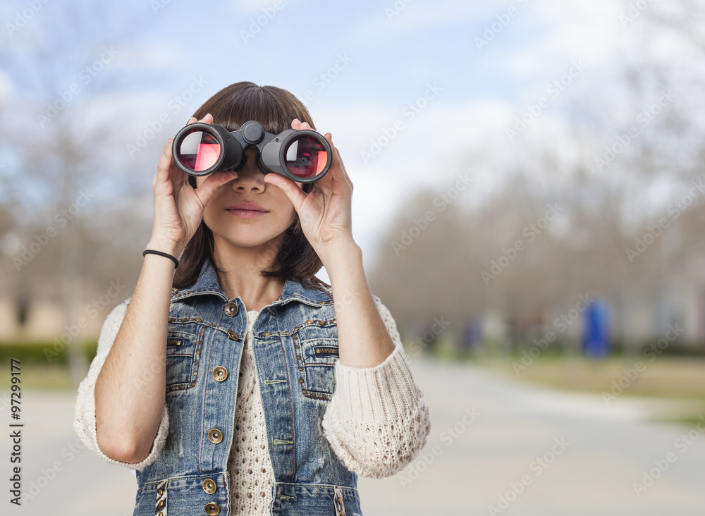 portrait of a pretty young woman looking through the binoculars portrait of a pretty young woman looking through the binoculars