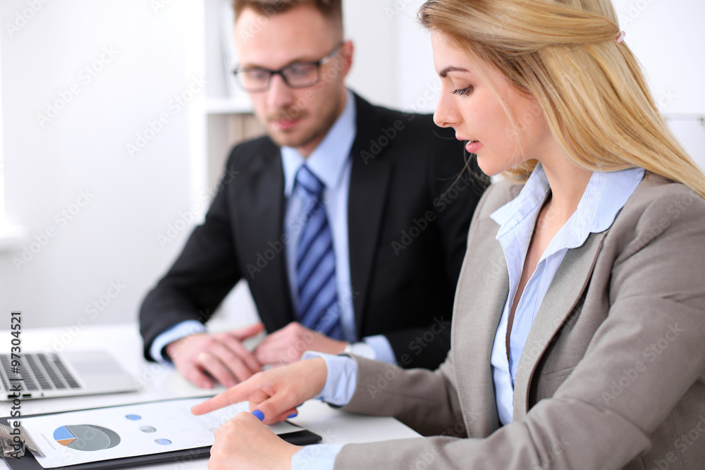 Two successful business partners working at meeting in office Two successful business partners working at meeting in office