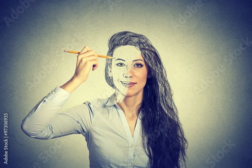 Obraz na plátně beautiful woman drawing self portrait with pencil