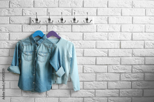Clothes for children on hangers in a room