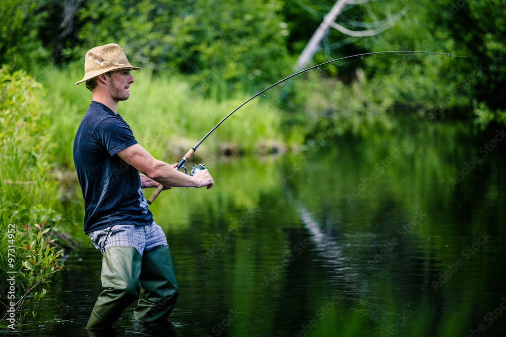 Young Fisherman Catching a big Fish Young Fisherman Catching a big Fish
