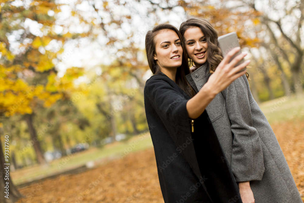 Young women taking selfie with smartphone outdoor Young women taking selfie with smartphone outdoor