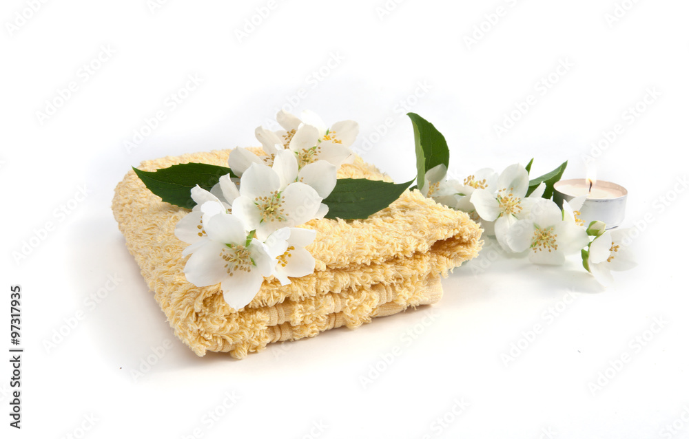 fresh jasmine flowers and a towel on a white background