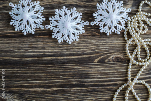 Snowflakes border on wooden background