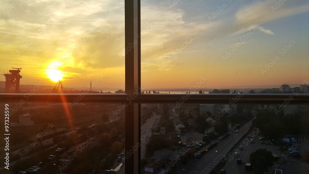 Capture the sunset over the city from the business office