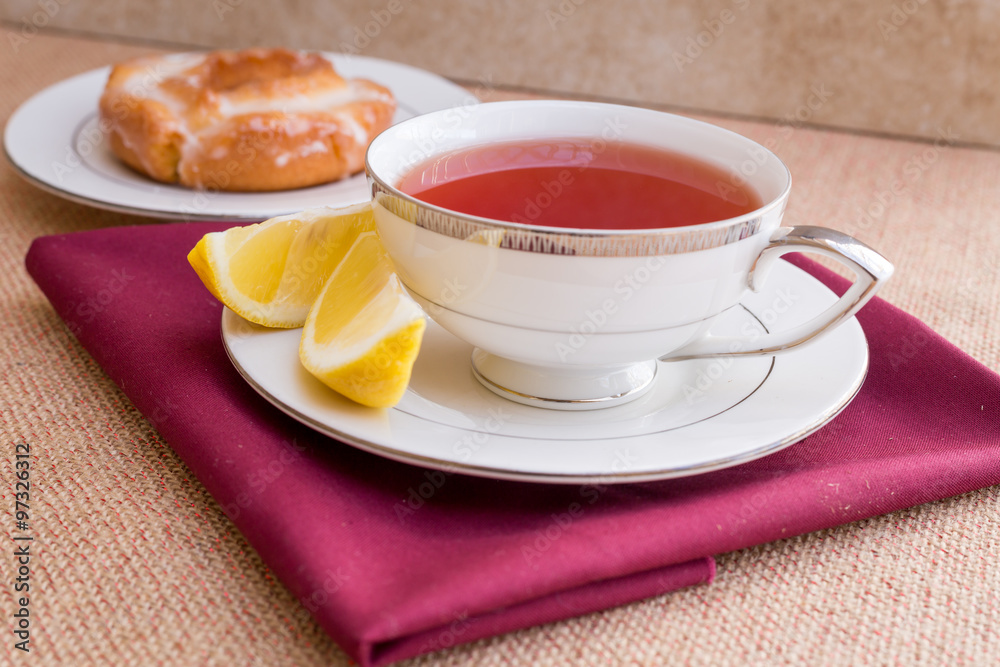 Breakfast with pastries, and hot tea with lemon.