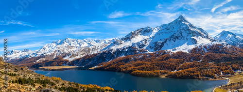 Panorama view of Sils lake and the Engadin Alps in golden autumn photo