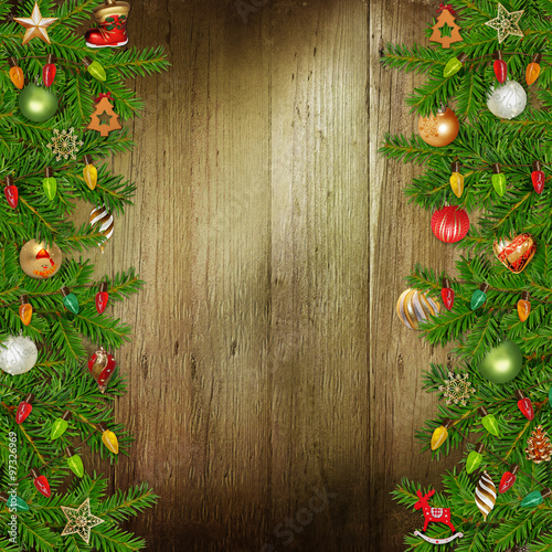Christmas congratulatory background with pine branches and Christmas ornaments on the wooden background