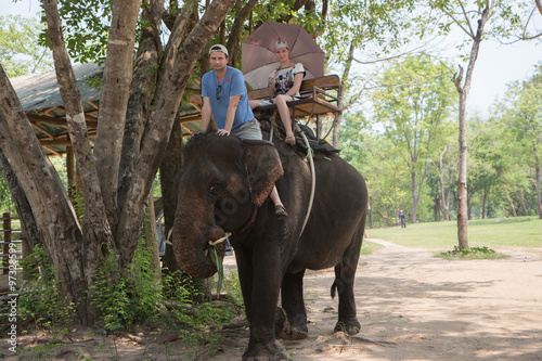 Two tourists travel by elephant