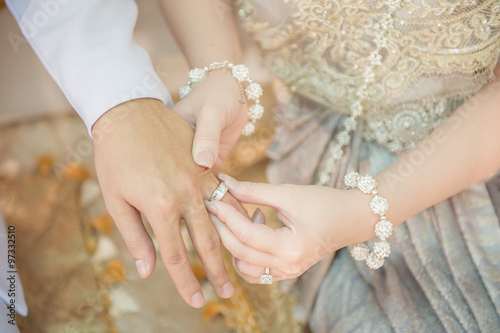 The bride wore a bride groom's wedding ring in traditional wedding ceremony Thailand