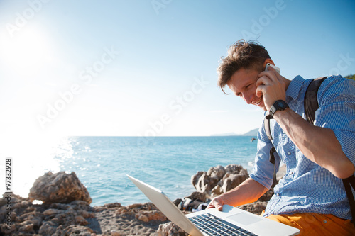 Freelancer on the laptop by the seaside