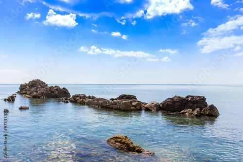 Big stone at seaside with blue sky © armcreation