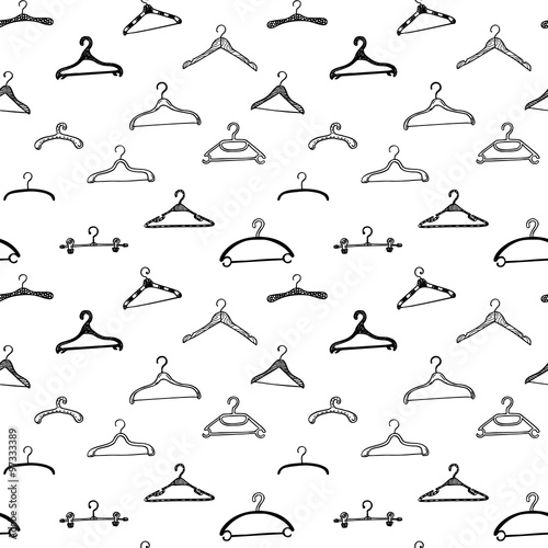 Fashion modern seamless pattern with doodle clothes hangers. Vector background.