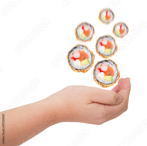 Rolls of sushi falling into a hand isolated on white background