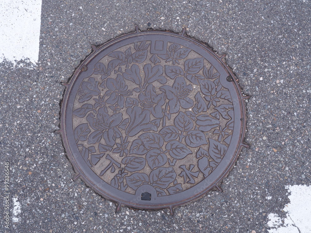 Manhole drain cover on the street at Takayama, Japan.