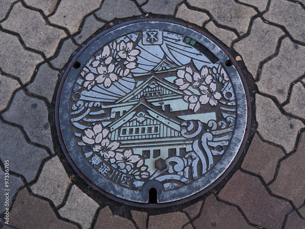 Manhole drain cover on the street at Osaka, Japan. 