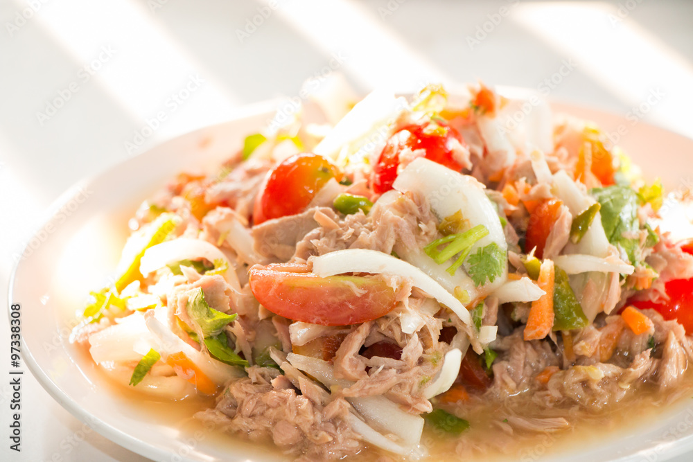 Spicy Tuna Salad onion and tomatoes in plate put on wooden background , Thailand cuisine. Spicy Tuna Salad onion and tomatoes in plate put on wooden background , Thailand cuisine.