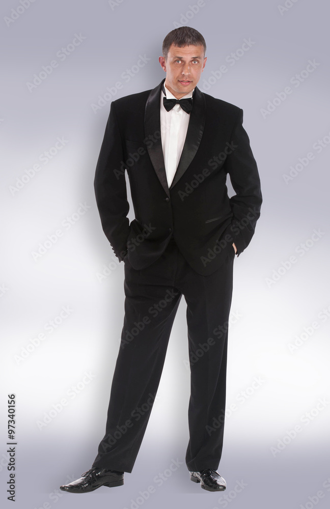 Caucasian adult man in classic tuxedo Caucasian adult man in classic tuxedo