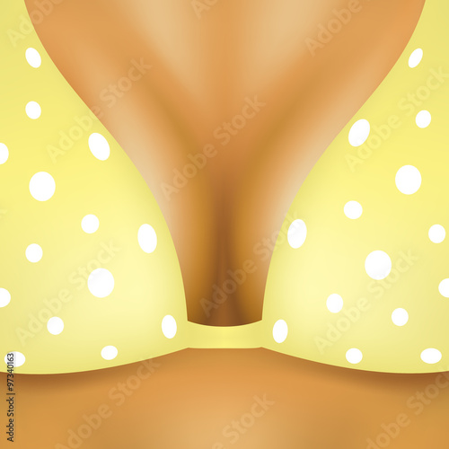 Breasts in yellow bra with white dots