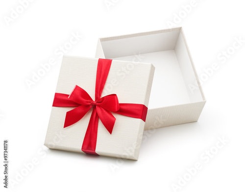 White open gift box with red bow isolated on white background - Clipping path included