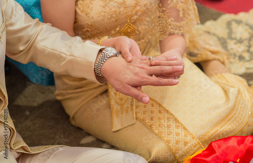 The bride wore a bride groom's wedding ring in traditional wedding ceremony Thailand