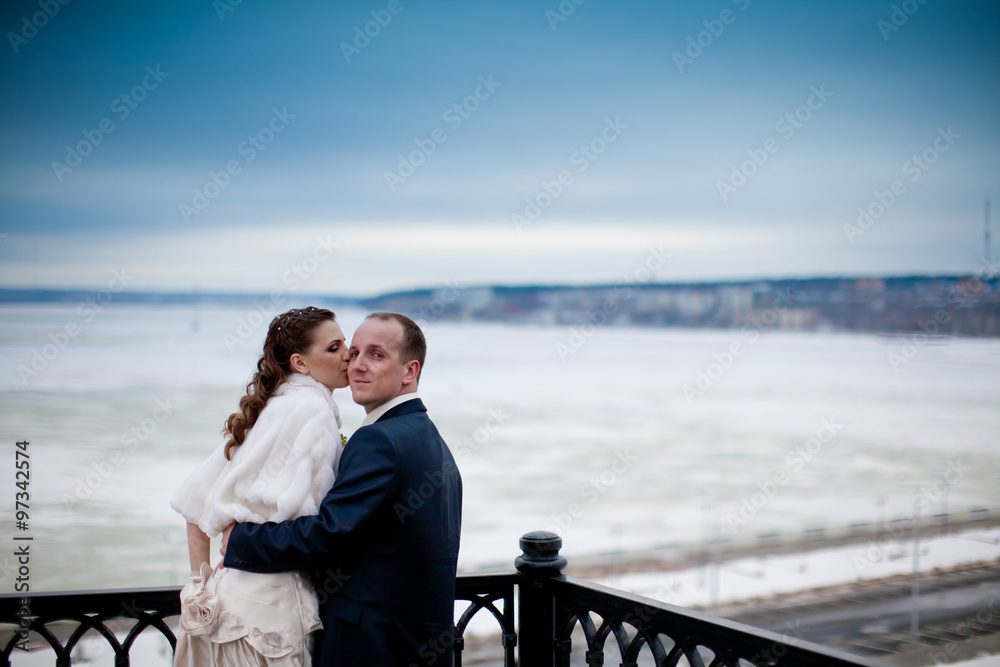 Bride and groom in winter snow city