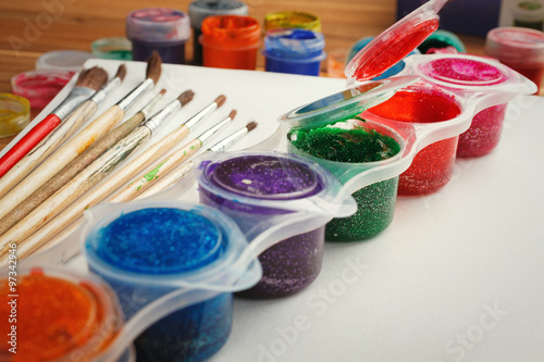 Paint brushes with opened paint bucket