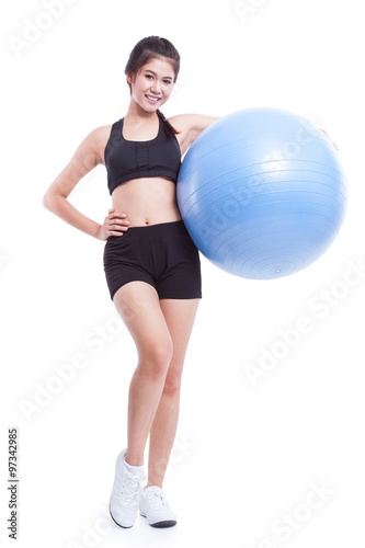 Young woman doing exercises with fitness ball 