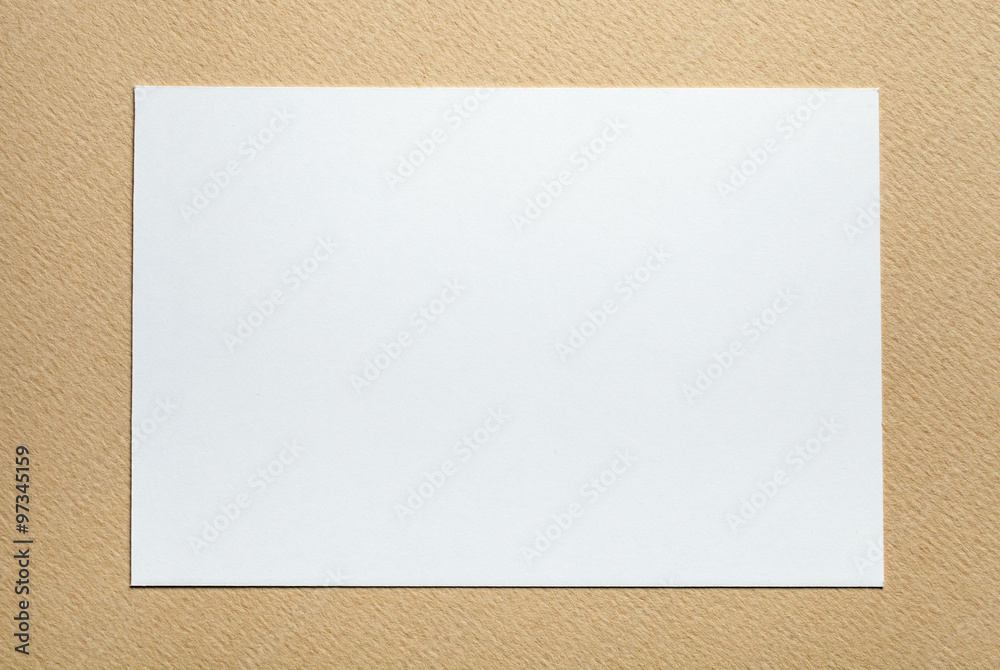 white paper card on beige background, place for text white paper card on beige background, place for text