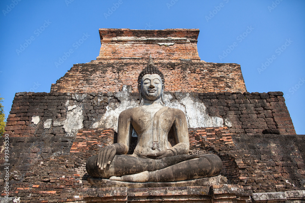 Statue of seated Buddha at ancient temple of Wat Mahathat in Sukhothai, Thailand Statue of seated Buddha at ancient temple of Wat Mahathat in Sukhothai, Thailand