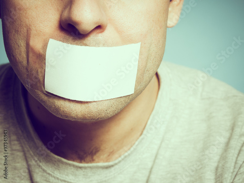 Caucasian man with duct tape on mouth, white .