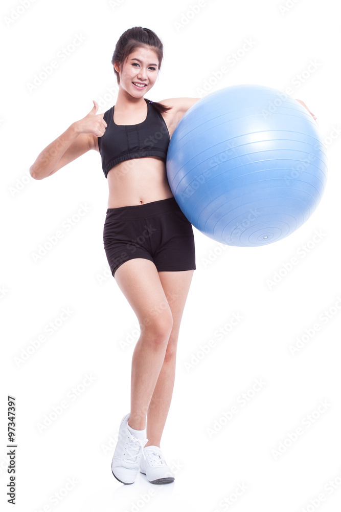Young woman doing exercises with fitness ball and showing thump up. Young woman doing exercises with fitness ball and showing thump up.