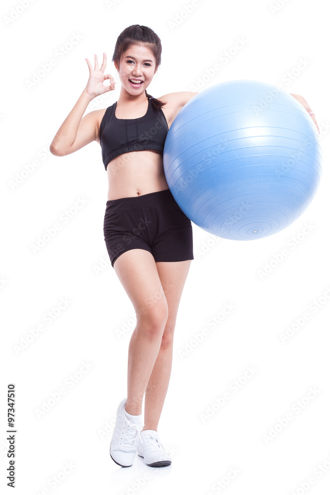 Young woman doing exercises with fitness ball and showing ok sign. Young woman doing exercises with fitness ball and showing ok sign.