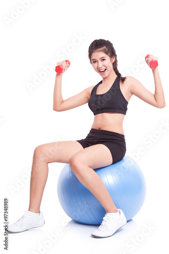 Fitness woman sport training with exercise ball and lifting weights