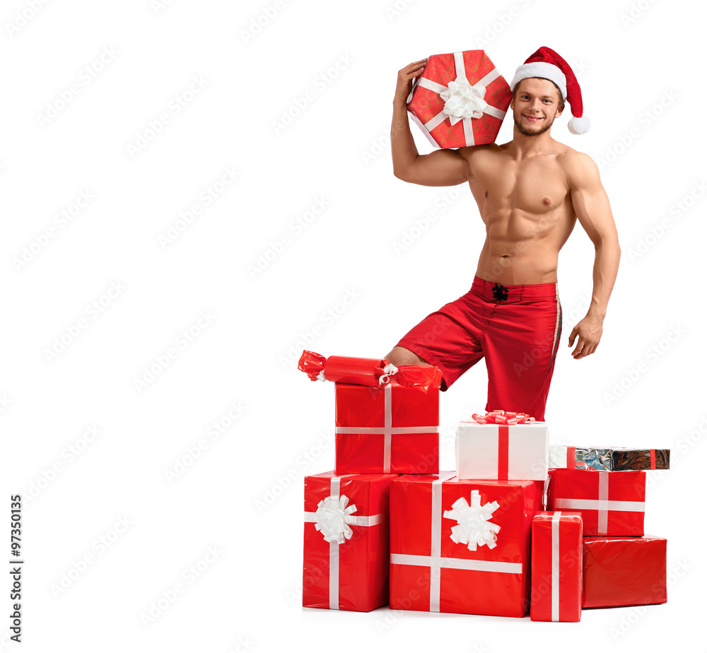 Special presents. Handsome Santa Claus holding a gift box posing in studio Special presents. Handsome Santa Claus holding a gift box posing in studio