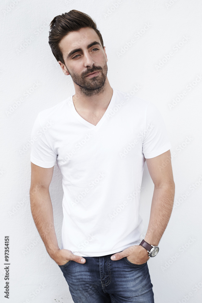 Contemplative young man in white t-shirt Contemplative young man in white t-shirt